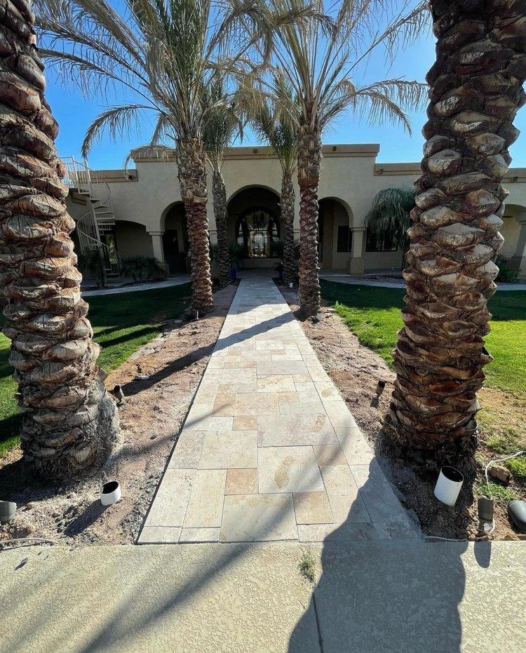 Travertine walkway lined with palm trees