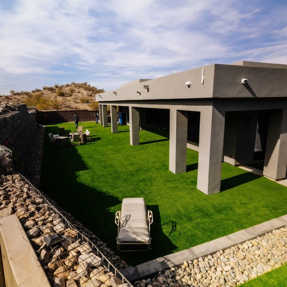 Modern desert home with turf yard and gabion wall