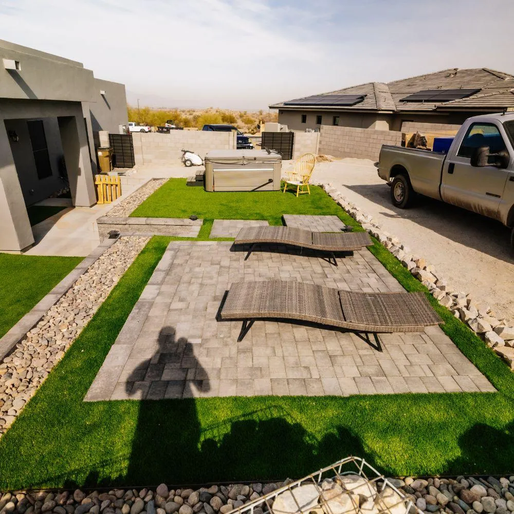 Backyard build with pavers, turf, and hot tub
