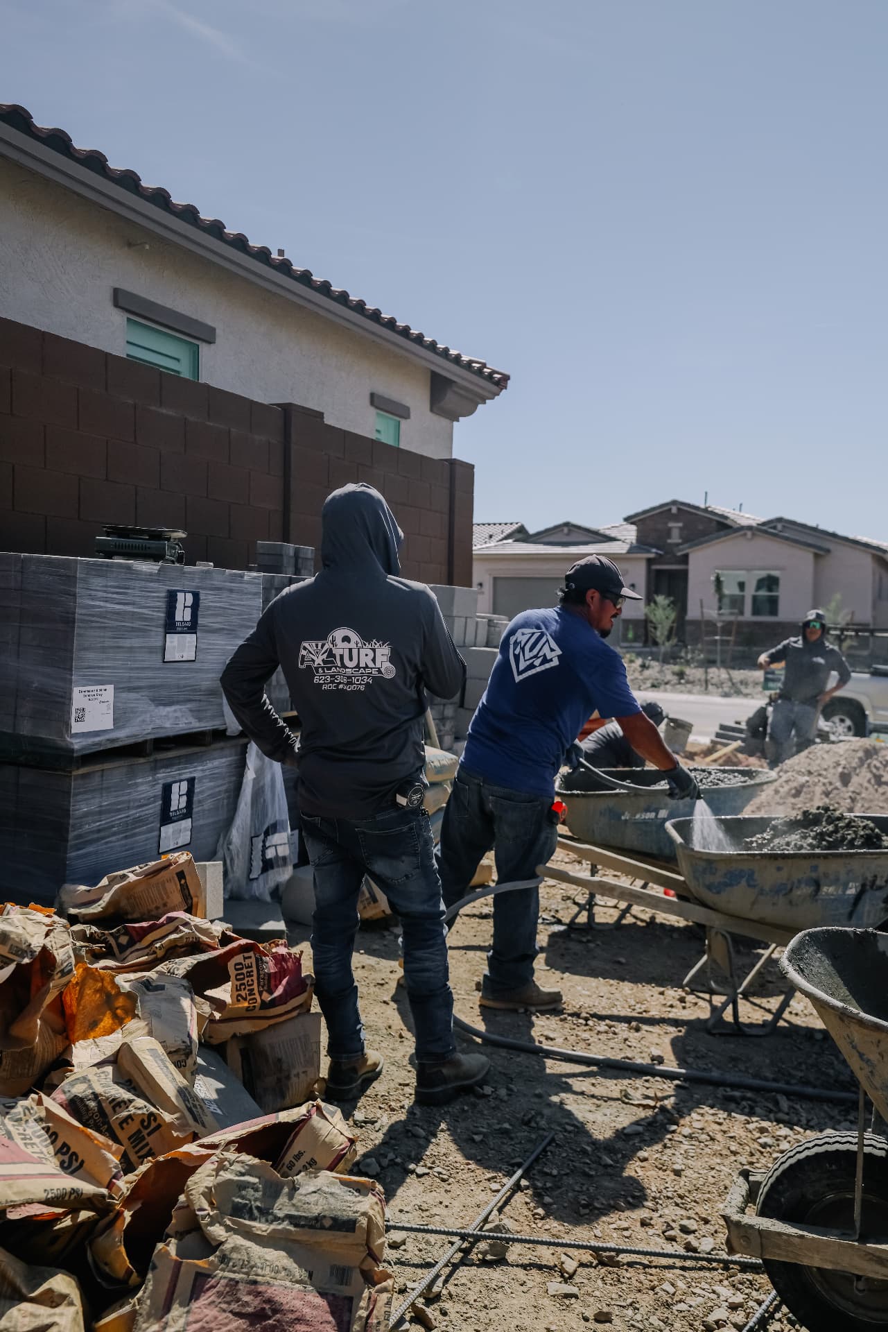 AZ Turf and Landscape crew mixing concrete during an outdoor construction project