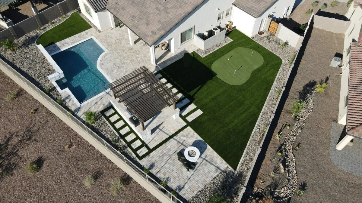 Aerial view of pool, pergola, and putting green backyard build
