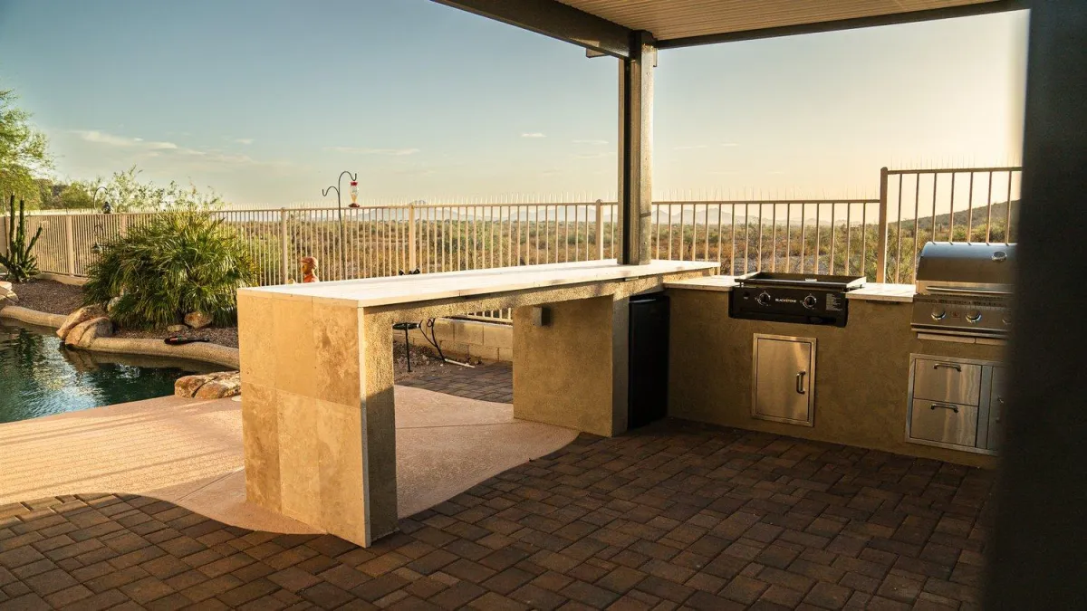 Outdoor kitchen bar with stainless grill overlooking desert