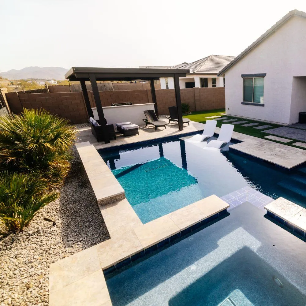 Modern pool and spa with travertine deck and pergola lounge