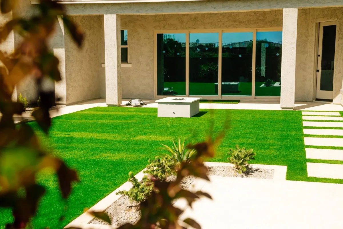 Modern turf courtyard with fire feature and paver walk
