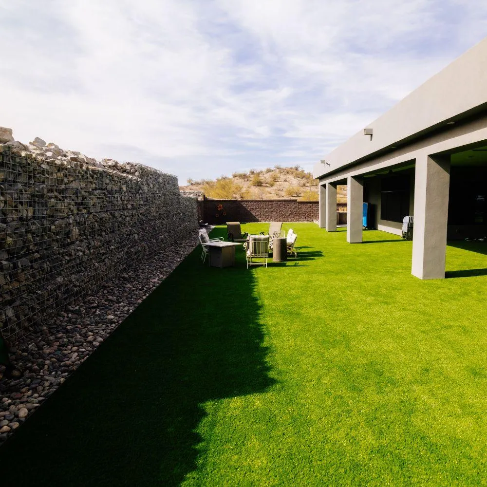 Turf yard with gabion retaining wall and covered patio