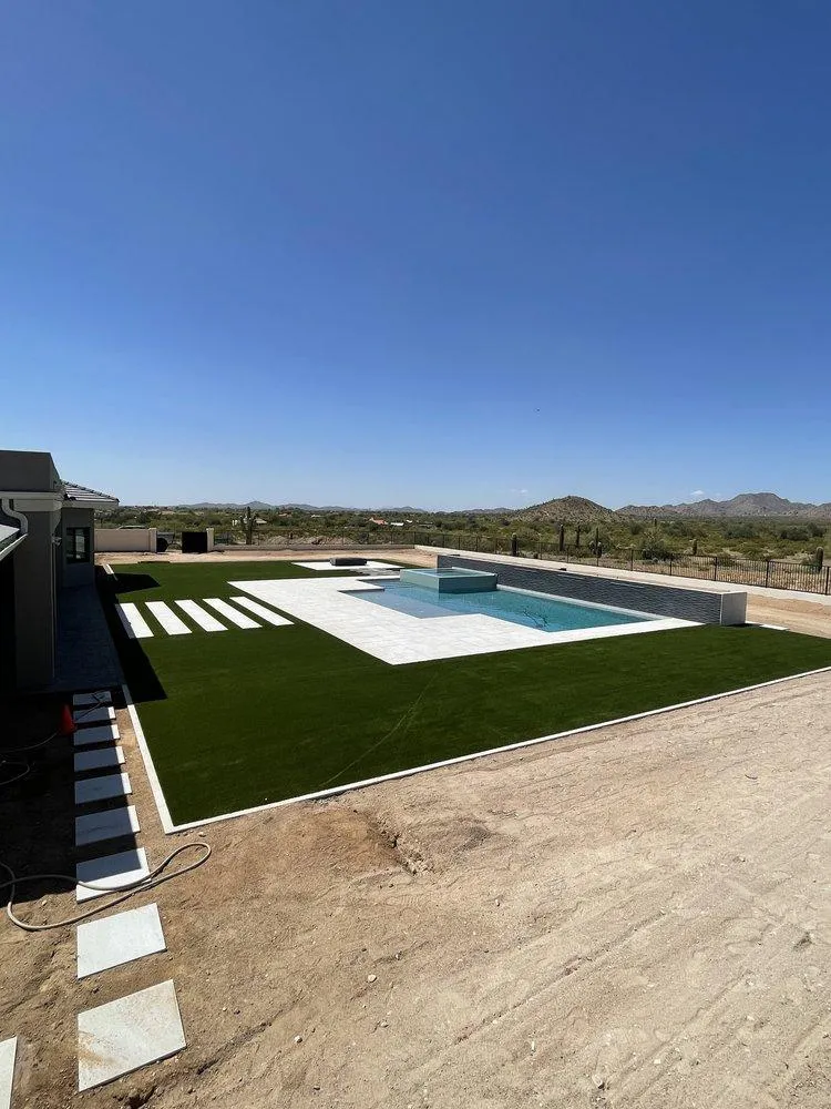 Modern pool and turf lawn with mountain and desert backdrop