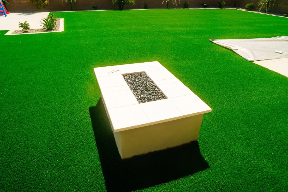 Custom fire feature centered on lush turf lawn