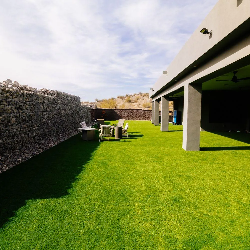 Wide turf lawn under covered patio with gabion wall