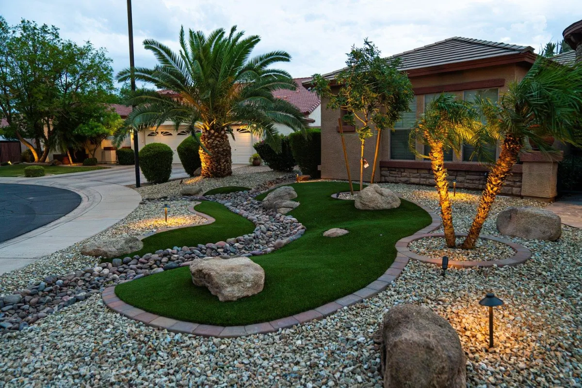Front yard turf and river rock design with evening lighting