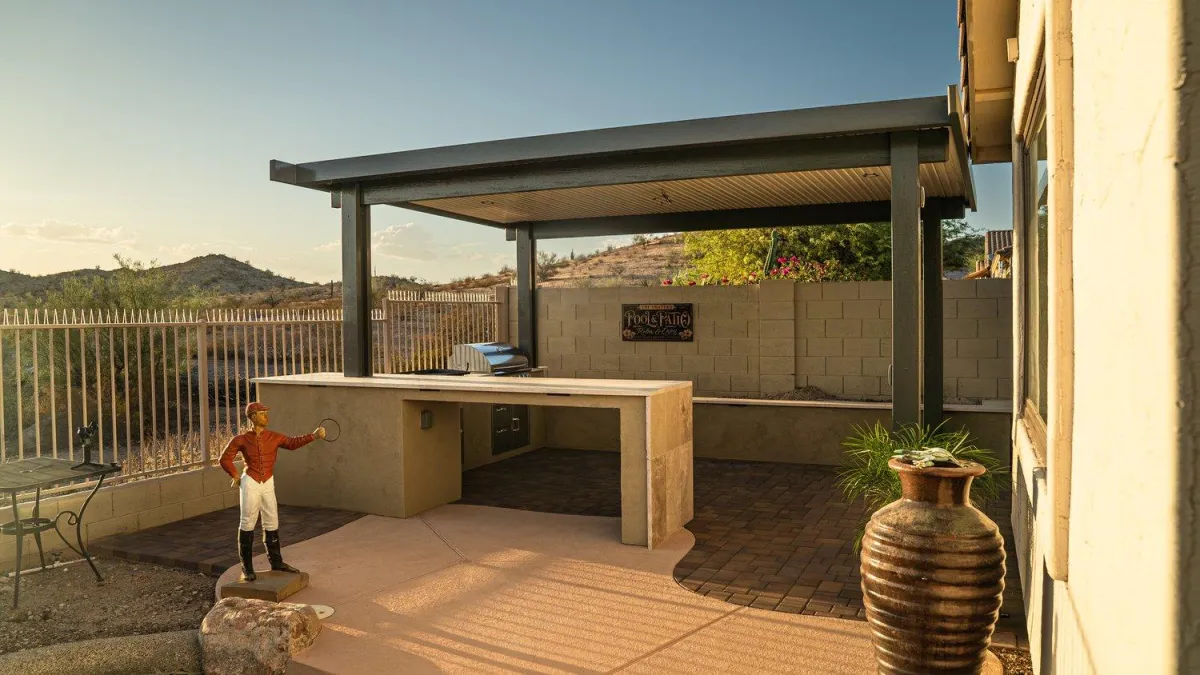 Covered outdoor kitchen with steel pergola and desert view